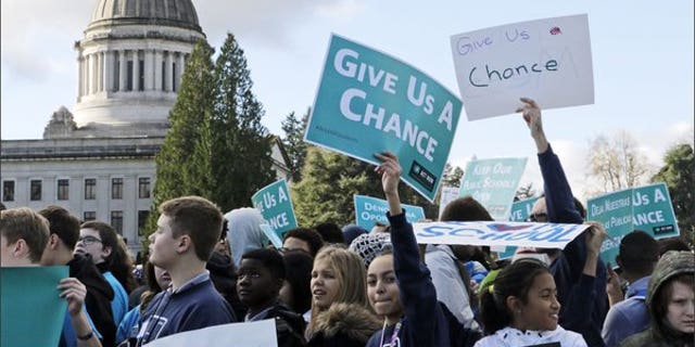 Students and other advocates of charter schools rally in Olympia, Wash., in November. A group of Republican governors is urging the Biden administration to scrap a proposed rule that would make it harder for charter schools to obtain federal funding. 