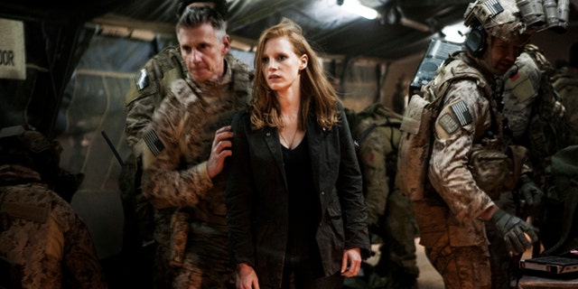 In this undated publicity photo released by Columbia Pictures Industries, Inc., Jessica Chastain, center, plays a member of the elite team of spies and military operatives, stationed in a covert base overseas, with Christopher Stanley, left, and Alex Corbet Burcher, right, who secretly devote themselves to finding Usama Bin Laden in Columbia Pictures' new thriller, "Zero Dark Thirty."