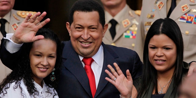 July 15: Venezuela President Hugo Chavez waves flanked by his daughters Rosa Virginia, right, and Gabriela, after he announced he will return to Cuba Saturday to begin a new phase of cancer treatment that will include chemotherapy at Miraflores presidential palace in Caracas, Venezuela.