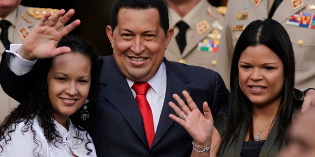 July 15: Venezuela President Hugo Chavez waves flanked by his daughters Rosa Virginia, right, and Gabriela, after he announced he will return to Cuba Saturday to begin a new phase of cancer treatment that will include chemotherapy at Miraflores presidential palace in Caracas, Venezuela.