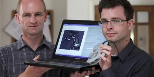 Jeff Neasham (L) and Dave Graham hold their low-cost ultrasound system in Newcastle on September 6, 2012. REUTERS/Newcastle University/Handout