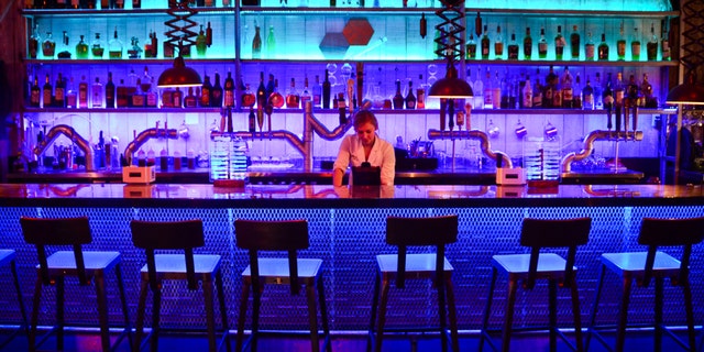 The Chemist - Craft Cocktails & Modern Cuisine -- looks like a scientist's laboratory, complete with beakers to drink from and servers wearing lab coats.