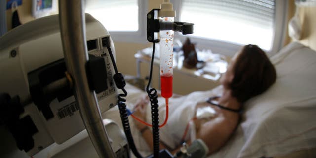 A patient receives chemotherapy treatment for breast cancer in France. (REUTERS/Eric Gaillard)