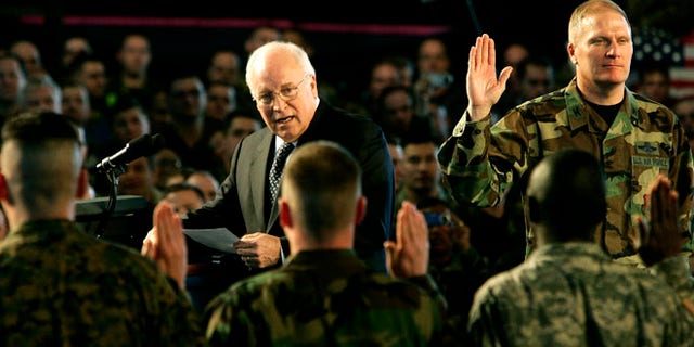 Mar. 21, 2006: U.S. Vice President Dick Cheney leads the reading of an oath with participants in a re-enlistment ceremony for U.S. Air Force Personnel during his visit to Scott Air Force Base in Illinois.