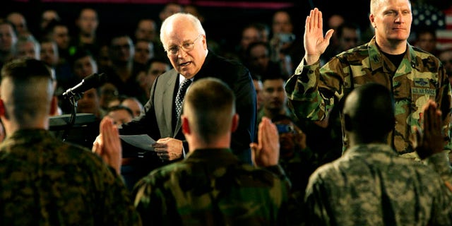 Mar. 21, 2006: U.S. Vice President Dick Cheney leads the reading of an oath with participants in a re-enlistment ceremony for U.S. Air Force Personnel during his visit to Scott Air Force Base in Illinois.