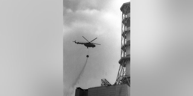 A helicopter dropping concrete onto the fourth reactor of the Chernobyl nuclear power after its explosion is seen in this 1986 file picture.