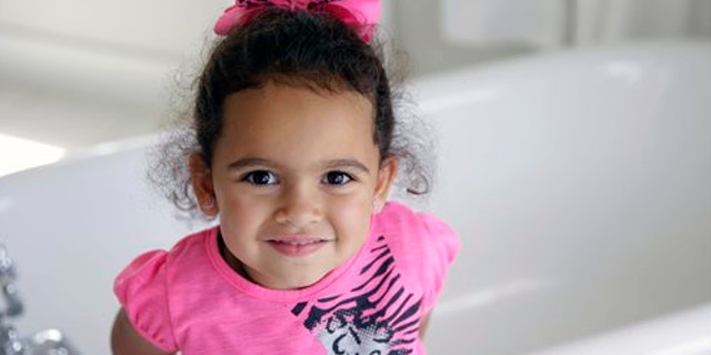 Aug. 6, 2013: Veronica, the 4-year-old Cherokee girl at the center of an adoption dispute, smiles in a bathroom of the Cherokee Nation Jack Brown Center in Tahlequah, Okla.