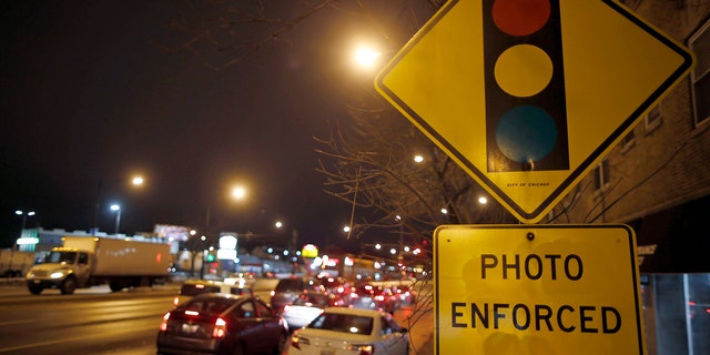 Cars approach an intersection where a red light camera is placed in Chicago, Illinois, February 9, 2015.