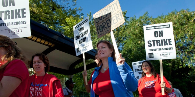 Public school teachers picket outside Amundsen High School on the first day of a strike by the Chicago Teachers Union, Monday, Sept. 10, 2012, in Chicago. (AP Photo/Sitthixay Ditthavong)