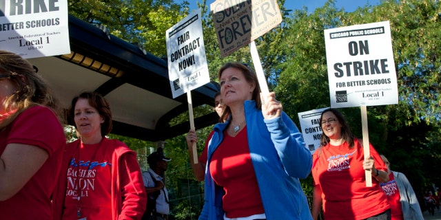 Public school teachers picket outside Amundsen High School on the first day of a strike by the Chicago Teachers Union, Monday, Sept. 10, 2012, in Chicago. (AP Photo/Sitthixay Ditthavong)