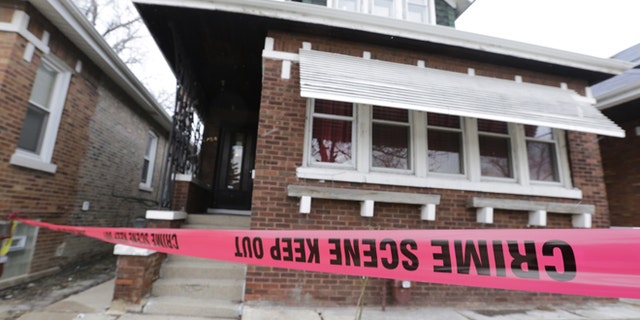 Feb. 5, 2016,: Crime scene tape surrounds a home in Chicago. (AP Photo/M. Spencer Green)