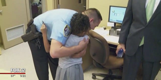 Seven-year-old Rosalyn Baldwin hugs a Chicago police officer