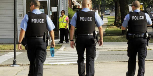 Police on patrol in Chicago. (AP Photos/M. Spencer Green)