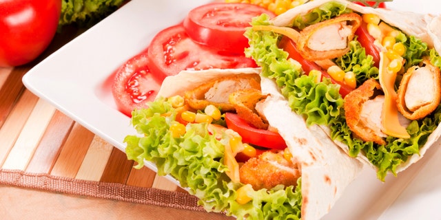 Fried chicken wraps on plate. Selective focus in the middle of chicken wraps.