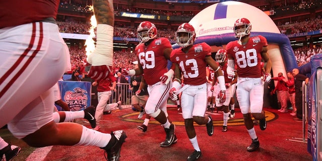 Dec 31, 2016; Atlanta, GA, USA; Alabama Crimson Tide wide receiver ArDarius Stewart (13) and his teammates take the field for the 2016 CFP Semifinal against the Washington Huskies at the Georgia Dome. Mandatory Credit: Jason Getz-USA TODAY Sports - RTX2X35I