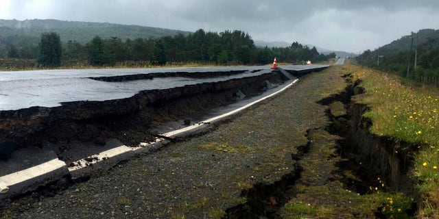 Cracks appear in and along a road near Quellon, Chile, Sunday, Dec. 25, 2016, after an earthquake. (Edinson Capdevilla/Aton via AP)
