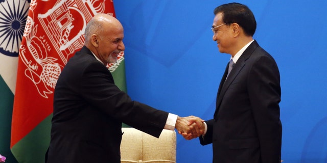 Chinese Premier Li Keqiang, right, shakes hands with Afghan President Ashraf Ghani Ahmadzai at opening ceremony of the 4th Ministerial Conference of Istanbul Process of Afghanistan.