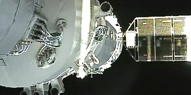 In this June 13, 2013, file image released by China's Xinhua News Agency, the Shenzhou-10 manned spacecraft is seen while conducting docking with the orbiting Tiangong-1 space module.