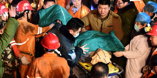 Dec. 25, 2015: In this photo released by China's Xinhua News Agency, a trapped miner is rescued from a collapsed gypsum mine in Pingyi County, east China's Shandong Province. (Guo Xulei/Xinhua via AP)