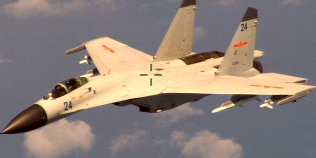 Aug. 19, 2014: This handout photo provided by the Office of the Defense Secretary (OSD), taken shows a Chinese fighter jet that the Obama administration said Friday conducted a "dangerous intercept" of a U.S. Navy surveillance and reconnaissance aircraft off the coast of China in international airspace.