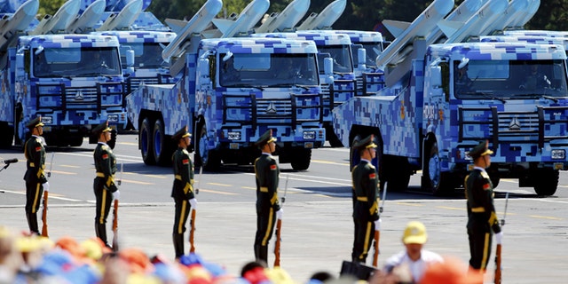 China's People's Liberation Army (PLA) navy soldiers on their armoured vehicles carrying ship-to-air missiles roll to Tiananmen Square during the military parade marking the 70th anniversary of the end of World War Two, in Beijing, China, September 3, 2015. REUTERS/Damir Sagolj - GF10000191226