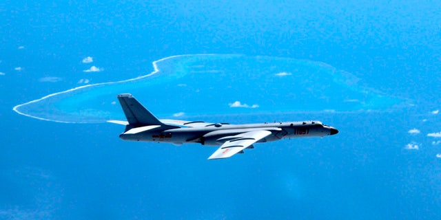 In this undated file photo released by Xinhua News Agency, a Chinese H-6K bomber patrols the islands and reefs in the South China Sea.