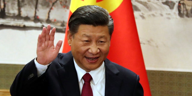 In this Oct. 25, 2017, file photo, Chinese President Xi Jinping waves while addressing the media as he introduced new members of the Politburo Standing Committee at Beijing's Great Hall of the People.