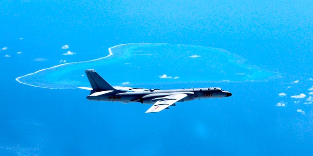 FILE - In this undated file photo released by Xinhua News Agency, a Chinese H-6K bomber patrols the islands and reefs in the South China Sea. The China Daily newspaper reported Saturday, May 19, 2018 that People's Liberation Army Air Force conducted takeoff and landing training with the H-6K bomber in the South China Sea. (Liu Rui/Xinhua via AP, File)