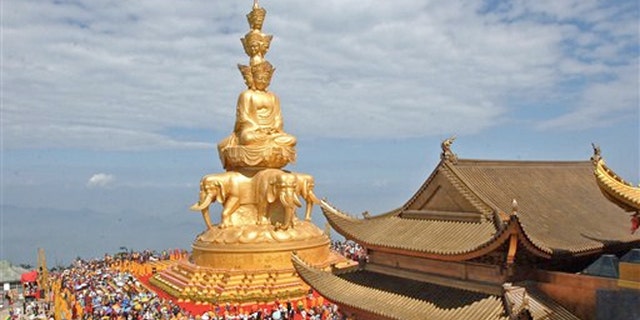 June 18, 2006: Worshippers attend a ceremony at the Jin Ding, or Golden Tip, on Emei Mountains in Emeishan city in southwest China's Sichuan province.