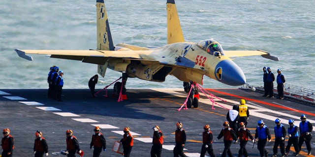 Nov. 25, 2012: This undated photo released by China's Xinhua News Agency, shows a carrier-borne J-15 fighter jet on China's first aircraft carrier, the Liaoning.