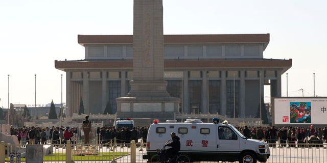 Oct. 29, 2013: An armored Chinese paramilitary vehicle is stationed near Tiananmen Square across the street from Tiananmen Gate, the site of an incident Monday where a car plowed through a crowd before it crashed and burned in Beijing, China.