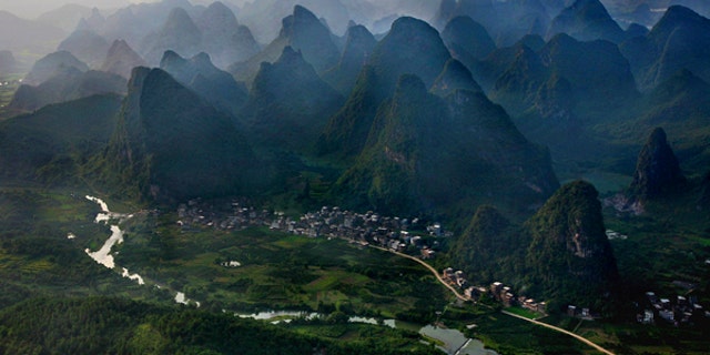Asia, China, Yangshuo, near Guilin, Guanxi, river Li with karst mountains at sunset, aerial view . -