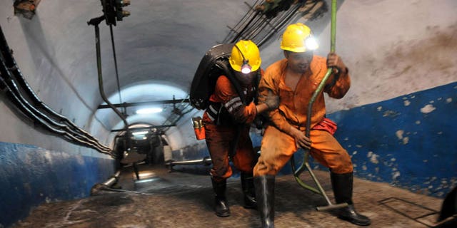 escuers are ready to go underground after an explosion at the state-run Pingyu Coal & Electric Co. Ltd mine in Yuzhou city, central China's Henan province, on Saturday Oct. 16, 2010. Rescuers battled dangerous levels of gas and the risk of falling coal as they worked to free 17 miners after the explosion at the coal mine in central China early Saturday.