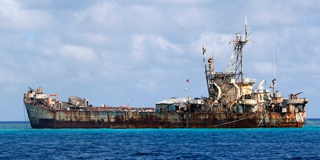 Mar. 30, 2014: A Chinese Coastguard vessel patrols near the BRP Sierra Madre, a marooned transport ship which Philippine Marines live on as a military outpost, in the disputed Second Thomas Shoal, part of the Spratly Islands in the South China Sea. (Reuters)