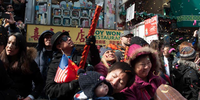 NEW YORK, NY - FEBRUARY 22: Revelers shoot confetti in the Chinese New Year parade in Manhattan's Chinatown on February 22, 2015 in New York City. The parade, now in it's 16th year, brought out hundreds of participants and viewers to celebrate the Year of the Sheep. (Photo by Bryan Thomas/Getty Images)
