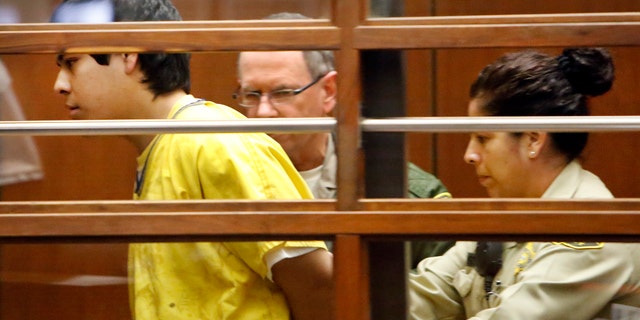 Jan. 12, 2015: Andrew Garcia, left, is led out of the courtroom by Sheriff's bailiffs after an outburst during an appearance in Los Angeles Superior Court Monday.