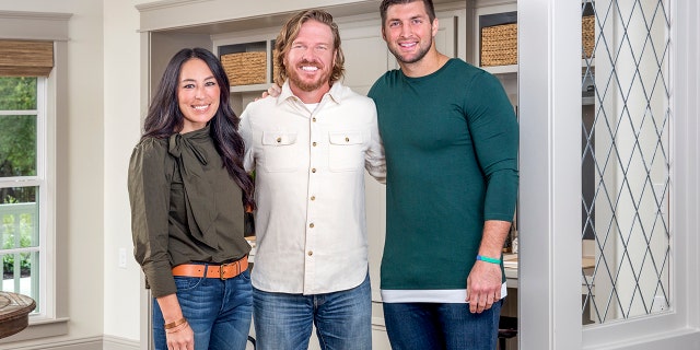 "Fixer Upper" stars Chip and Joanna Gaines pose with Tim Tebow, right. Tebow wrote the couple's TIME 100 tribute, which was released Wednesday.