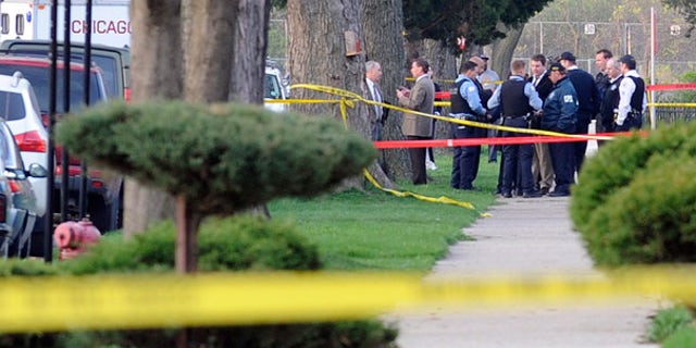 April 14: Chicago Police and investigators are seen following a shooting that left four people dead, including two children.