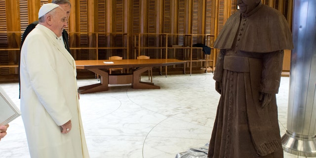Feb. 6, 2014 - Pope Francis stands in front of a lifesize statue of chocolate of himself. The statue, made with 1.5 tons of cocoa, was presented to the Pope during the general audience of Feb. 5.