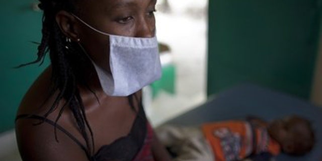 A woman waits with her son who suffers from cholera symptoms at the hospital in Archaie, Haiti, Tuesday Nov. 9, 2010. A confirmed case of cholera had never been seen in this Caribbean country before October and has killed at least 580 people and hospitalized thousands.
