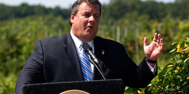 New Jersey Gov. Chris Christie stands near an orchard as he addresses a gathering Wednesday, Aug. 17, 2011, at Terhune Orchard in Princeton, N.J.