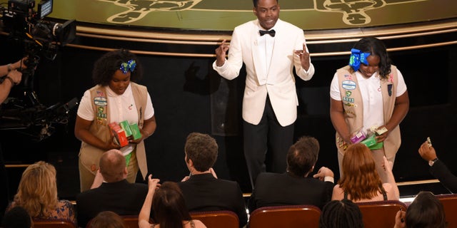 Host Chris Rock sells Girl Scout cookies in the audience at the Oscars on Sunday, Feb. 28, 2016, at the Dolby Theatre in Los Angeles. (Photo by Chris Pizzello/Invision/AP)