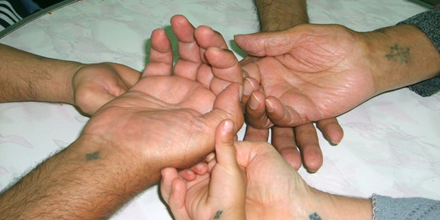 Coptic Christians identify themselves with tattoos of the Coptic cross (Aid to the Church in Need-US)
