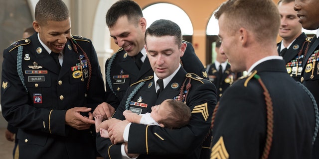 The soldiers who served alongside late Army Specialist Chris Harris gathered on May 29 to pose with the daughter he never met.