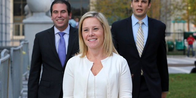 FILE - In this Wednesday, Oct. 19, 2016 file photo, Gov. Chris Christie's former Deputy Chief of Staff Bridget Anne Kelly, center, leaves Martin Luther King Jr. Courthouse after a hearing, in Newark, N.J. Kelly, who prosecutors say sent the "time for some traffic problems" email that started the George Washington Bridge lane-closing scandal is set to testify in her own defense. Kelly is expected to take the stand later Friday, Oct. 21, 2016, in federal court in Newark. (AP Photo/Mel Evans, File)