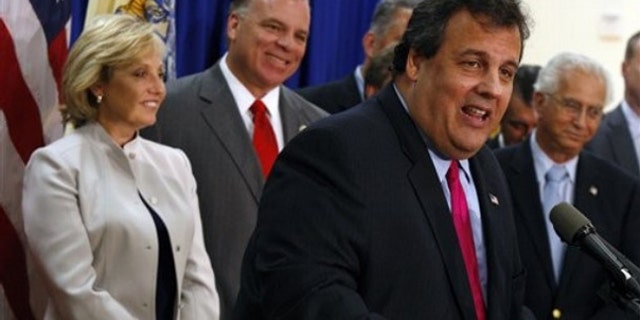 FILE: New Jersey Gov. Chris Christie, backed by Lt. Gov. Kim Guadagno and New Jersey Senate President Stephen Sweeney, speaks after signing the Property Tax Cap bill into law on July 13, 2010.
