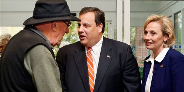 Monday: Republican gubernatorial candidate Chris Christie greets supporter Ben Ross, left, as lieutenant governor candidate Kim Guadagno, looks on in Tinton Falls, N.J. (AP Photo)