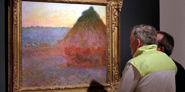 FILE - In this Nov. 4, 2016, file photo, Claude Monet's "Grainstack" is displayed at Christie's, in New York. The 1891 painting being offered Wednesday, Nov. 16, 2016, is one of a few still in private hands. (AP Photo/Richard Drew, File)