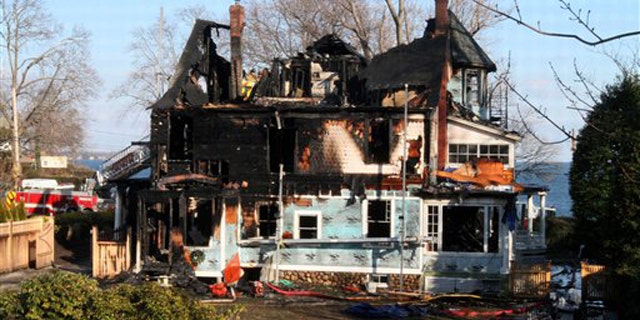 Dec. 25, 2011: In this file photo, firefighters investigate a house where an early morning fire left five people dead, in Stamford, Conn.