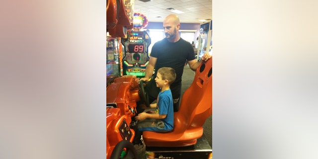 Austin Moniz, and his dad, Michael Moniz, enjoy playing a driving game during Sensory Sensitive Sunday at Chuck E. Cheese’s.
